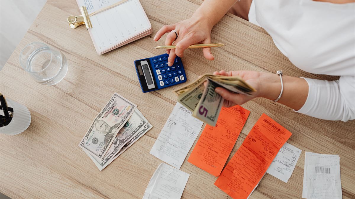 Calculator, cash and receipts on a desk